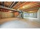 Unfinished basement with concrete floor, exposed ceiling and structural elements, plus framing at 9620 Mallard Pond Way, Littleton, CO 80125