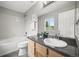 Bright bathroom with granite counters, white cabinets, and shower over tub at 9620 Mallard Pond Way, Littleton, CO 80125