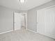 Bedroom with closet, carpet, neutral paint, and two doorways that create easy access at 9620 Mallard Pond Way, Littleton, CO 80125