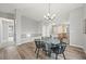 Open concept dining area with adjacent stairs, kitchen, and wood flooring at 9620 Mallard Pond Way, Littleton, CO 80125