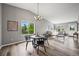 Bright dining area with wood floors and view to the living room with modern decor at 9620 Mallard Pond Way, Littleton, CO 80125