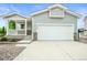 Charming home with attached two-car garage, covered porch and stone accents at 9620 Mallard Pond Way, Littleton, CO 80125
