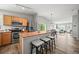 Open concept kitchen with breakfast bar, stainless steel appliances, and hardwood floors at 9620 Mallard Pond Way, Littleton, CO 80125