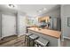 Bright kitchen with stainless steel appliances, breakfast bar, and hardwood floors at 9620 Mallard Pond Way, Littleton, CO 80125