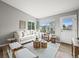 Cozy living room with natural light, modern furniture, and wood floors at 9620 Mallard Pond Way, Littleton, CO 80125