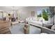Bright living room with modern decor, wood floors, and windows with view to backyard at 9620 Mallard Pond Way, Littleton, CO 80125