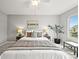 Comfortable bedroom with carpet flooring, natural light, and a ceiling fan at 9620 Mallard Pond Way, Littleton, CO 80125