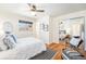 Bedroom boasts wood floors, ceiling fan, and mirrored closet at 1623 S Ivy Way, Denver, CO 80224