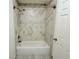 Updated bathroom includes a tub and shower combination with tiled walls at 8260 Washington St # 78, Denver, CO 80229