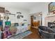 View of the bedroom leading to dining area with hardwood floors and fireplace at 8260 Washington St # 78, Denver, CO 80229