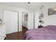 Cozy bedroom featuring hardwood floors, closet, and an adjacent laundry area for added convenience at 8260 Washington St # 78, Denver, CO 80229
