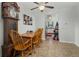 Bright dining area with a ceiling fan and tiled floor leading to kitchen at 8260 Washington St # 78, Denver, CO 80229