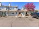 Well-maintained townhome with private parking, front porch, and blooming tree at 8260 Washington St # 78, Denver, CO 80229