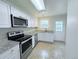 Updated kitchen features stainless appliances, white cabinets and granite countertops at 8260 Washington St # 78, Denver, CO 80229