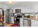 Well-lit kitchen with white cabinets, modern appliances, and granite countertops at 8260 Washington St # 78, Denver, CO 80229