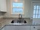 Modern kitchen sink with granite countertops and stainless steel faucet at 8260 Washington St # 78, Denver, CO 80229