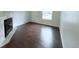 Bright living room with a tile fireplace and hardwood floors at 8260 Washington St # 78, Denver, CO 80229