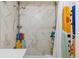 Updated shower showcasing elegant marble-style tiling and modern fixtures at 8260 Washington St # 78, Denver, CO 80229