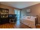 Bedroom with laminate floors, a bed, work desk and patio door at 3414 S Eagle St # 201, Aurora, CO 80014