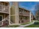 Charming apartment exterior featuring private balconies, stone accents, and well-maintained landscaping at 3414 S Eagle St # 201, Aurora, CO 80014
