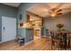 Open kitchen and dining area with wood floors and stainless steel appliances at 3414 S Eagle St # 201, Aurora, CO 80014