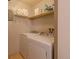 Laundry room with a white washer and dryer, and storage shelves at 3414 S Eagle St # 201, Aurora, CO 80014