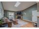 Bright living room with a fireplace and a sliding glass door to the balcony at 3414 S Eagle St # 201, Aurora, CO 80014