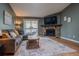 Cozy living room showcasing a fireplace, TV, and a sliding door to a balcony at 3414 S Eagle St # 201, Aurora, CO 80014