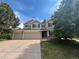 Charming two-story home with a three car garage, manicured lawn, mature trees and classic curb appeal at 17130 Opal Hill Dr, Parker, CO 80134