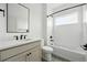Modern bathroom features black fixtures and a shower-over-tub combination and gray tile flooring at 924 Sunflower St, Louisville, CO 80027