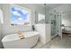 Bright bathroom with a soaking tub, walk-in shower, and views of the neighborhood at 924 Sunflower St, Louisville, CO 80027