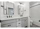 Elegant bathroom featuring dual vanity sinks, black hardware, and tub-shower combo at 924 Sunflower St, Louisville, CO 80027