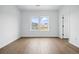 Bright bedroom with hardwood floors and two windows offering neighborhood views at 924 Sunflower St, Louisville, CO 80027