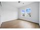 Bedroom boasts hardwood floors, ample light, and two windows with neighborhood views at 924 Sunflower St, Louisville, CO 80027