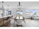 Bright dining room featuring modern light fixture, hardwood floors, and large windows overlooking the neighborhood at 924 Sunflower St, Louisville, CO 80027