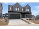 Modern two-story home featuring a two-car garage, covered porch, and contemporary design elements at 924 Sunflower St, Louisville, CO 80027