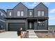 Contemporary two-story home with a covered porch, black trim, and modern architectural details at 924 Sunflower St, Louisville, CO 80027