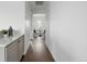 Hallway with hardwood floors leads to a dining area with a small table and chairs at 924 Sunflower St, Louisville, CO 80027