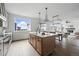 Open kitchen featuring a large island, stainless steel dishwasher, and view to living area at 924 Sunflower St, Louisville, CO 80027