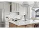 Bright kitchen with a quartz countertop island, stainless steel fridge, and chevron backsplash at 924 Sunflower St, Louisville, CO 80027