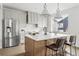 Stylish kitchen featuring an island with seating, stainless steel appliances, and modern finishes at 924 Sunflower St, Louisville, CO 80027