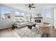 Bright living room featuring modern furniture, a tiled fireplace, and large windows at 924 Sunflower St, Louisville, CO 80027