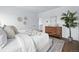 Inviting main bedroom features light walls, a wood dresser, and a large bed with soft blankets at 924 Sunflower St, Louisville, CO 80027
