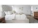 Comfortable main bedroom features a tufted headboard and natural lighting from the window at 924 Sunflower St, Louisville, CO 80027