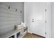 Functional mudroom with gray wainscoting, bench seating, and coat hooks for organization at 924 Sunflower St, Louisville, CO 80027