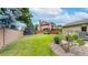Large grassy backyard surrounded by a wood fence, rocks and lots of trees at 5723 S Kittredge St, Centennial, CO 80015