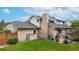Exterior view of home featuring brick facade, lawn, and an outdoor patio at 5723 S Kittredge St, Centennial, CO 80015