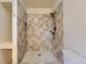 Tiled shower stall featuring modern fixtures and a rainfall shower head at 5723 S Kittredge St, Centennial, CO 80015