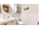 Charming bathroom features a pedestal sink, toilet, and a decorative cabinet with 'Bath' wall art at 5723 S Kittredge St, Centennial, CO 80015