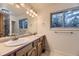 Bathroom featuring a double vanity, a large mirror, and natural light at 5723 S Kittredge St, Centennial, CO 80015